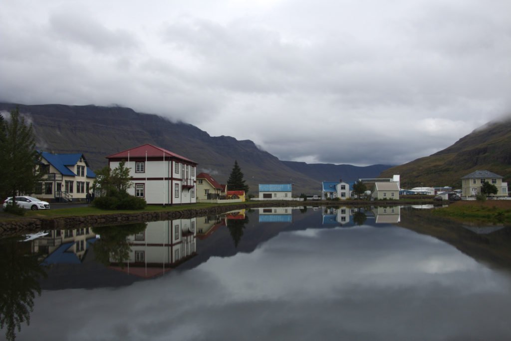 Maisons colorées et leur reflet sur l'eau à Seyðisfjörður dans la région des fjords de l'Est